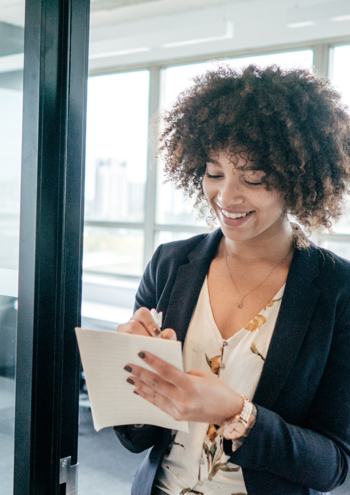 Business woman writing in a notepad