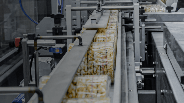 Engineer working on automated production line in a UK food manufacturing facility