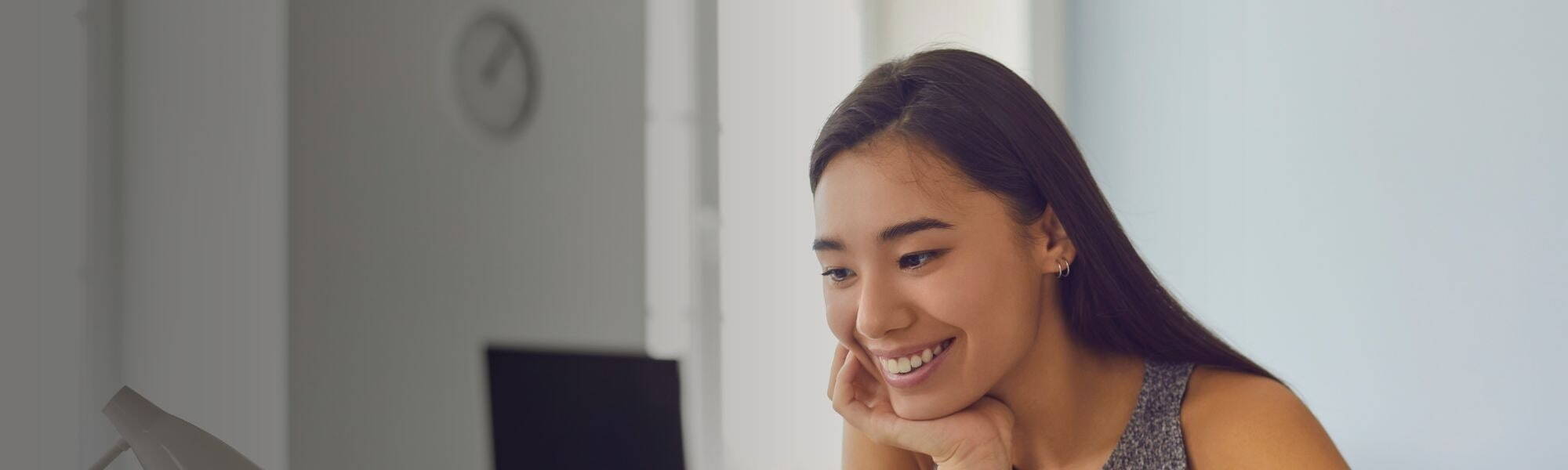 A woman looking focused and motivated at her laptop, symbolising the positive employee engagement effective leadership can create